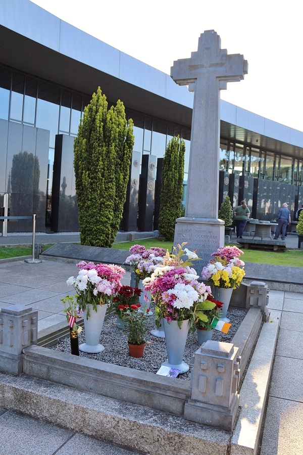 a grave with lots of flowers on it