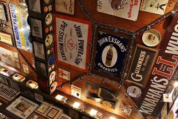 signs on the ceiling of an Irish pub