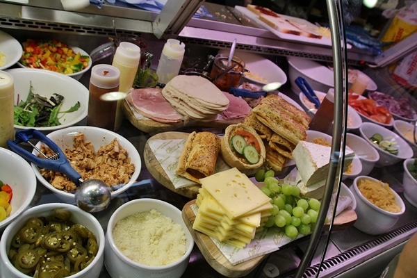 a display of sandwiches in a glass case in a cafe