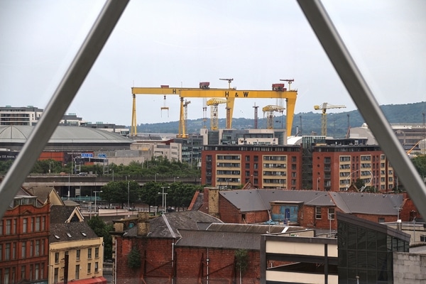 yellow cranes in the distance, viewed from a rooftop