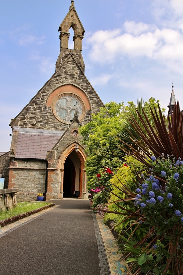 A stone church with flowers in front