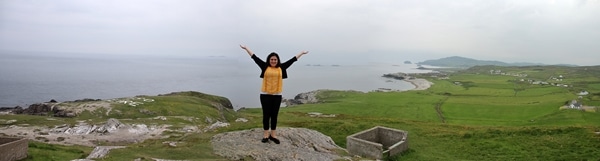 A person standing on a rock at Malin Head overlooking the sea