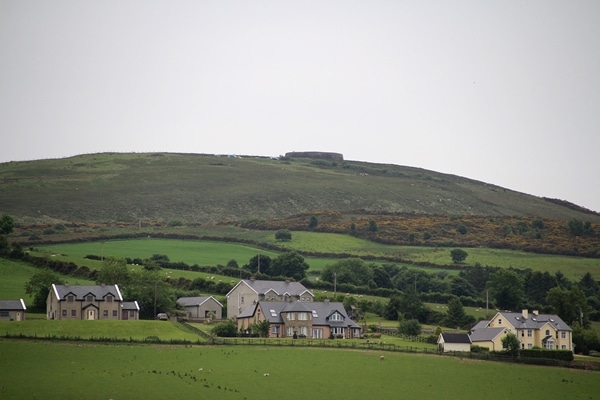 houses surrounded by vast green fields