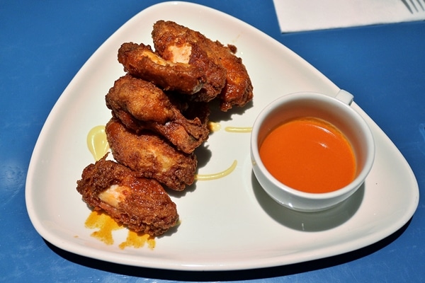 a plate of fried chicken wings with sauce