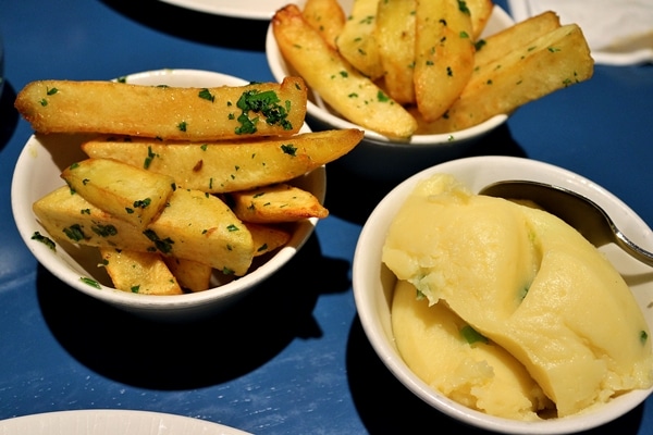 bowls of fried and mashed potatoes