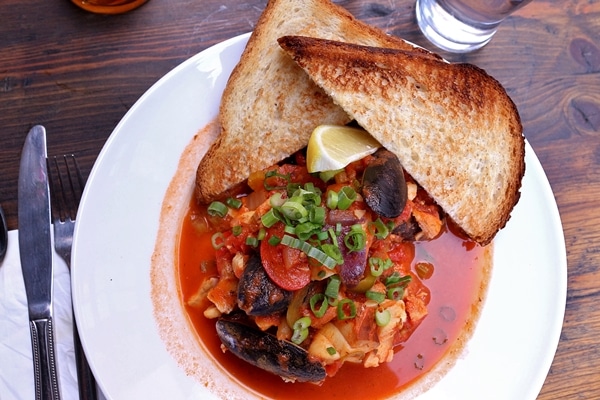 a seafood stew with toasted bread