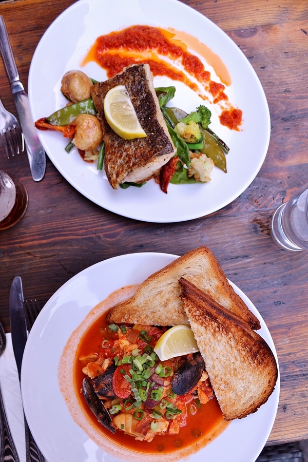 overhead view of plates of food on a wooden table