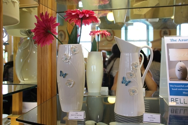 a vase and pitcher with butterflies and flowers on them