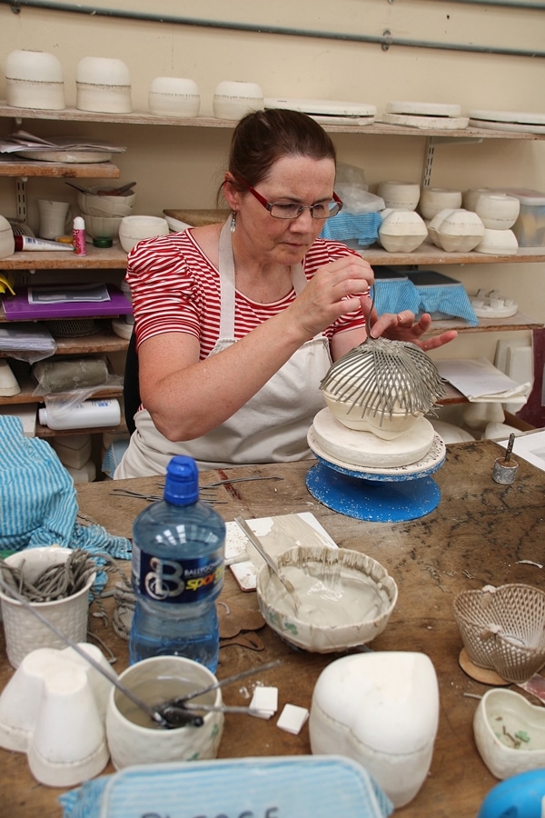 A woman making latticed pottery