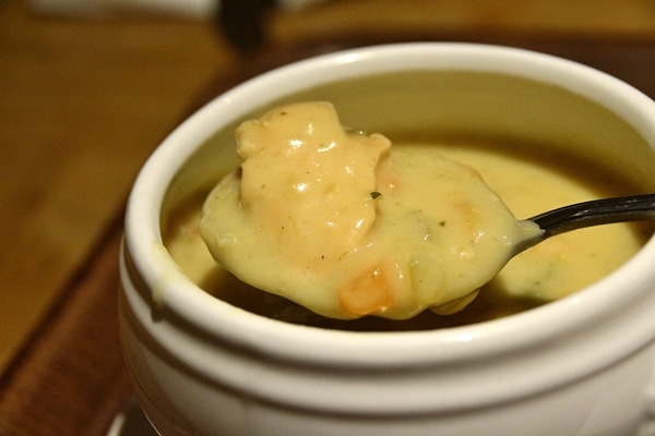 A close up of a spoonful of seafood chowder