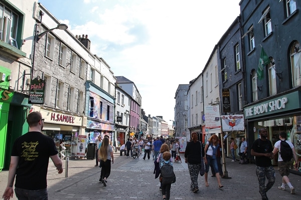 A group of people walking on a city street