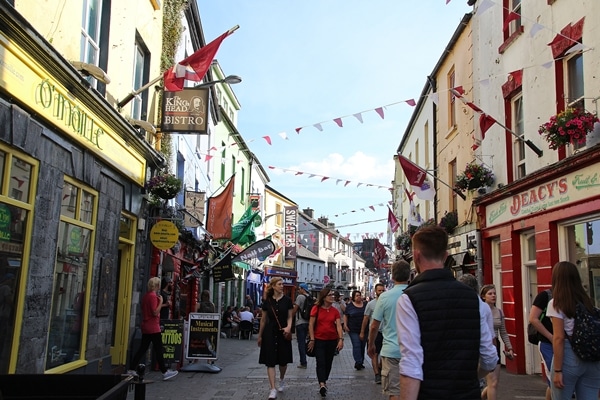 A group of people walking on a pedestrian street