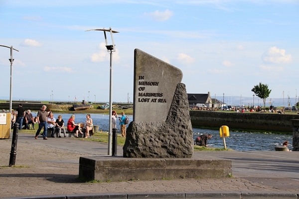 A stone monument near a body of water