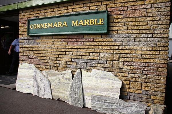 A stone building that has a sign that says Connemara Marble