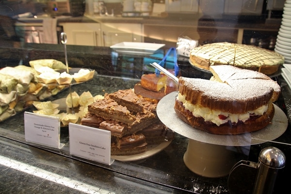 a display of desserts for sale in a cafe