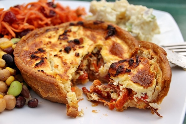 A close up of a small quiche on a plate