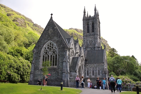 A group of people walking in front of a church