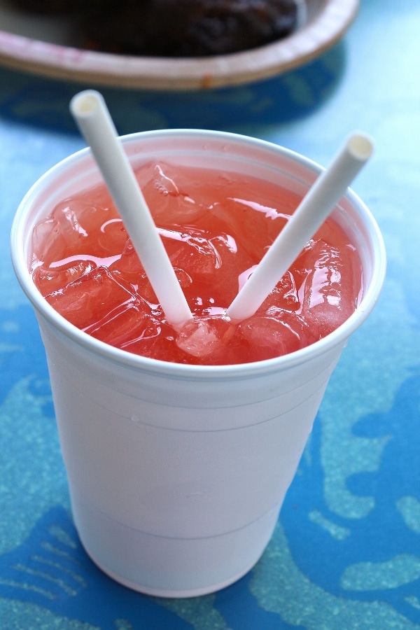 a cup of pink lemonade with 2 straws