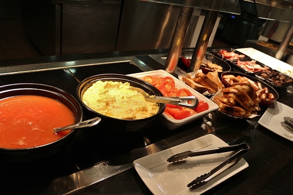 various hot breakfast foods on a buffet