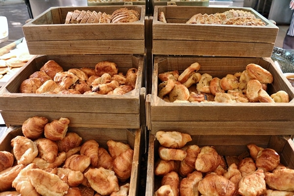 small croissants and pastries on a breakfast buffet