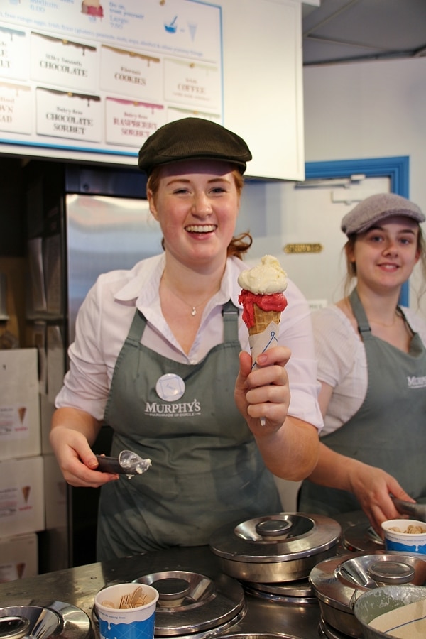 a woman holding an ice cream cone