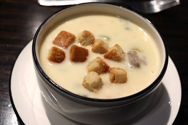 A bowl of creamy soup with croutons