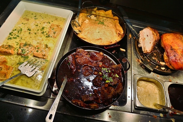 several different food items on a buffet line