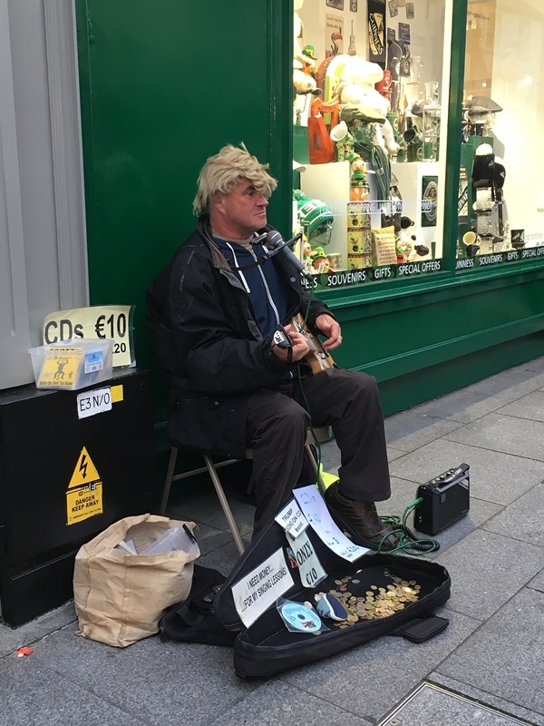 a man playing a guitar on the street