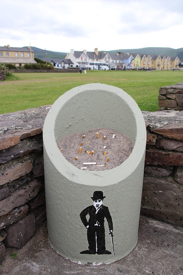 a large ashtray with a painting of Charlie Chaplin on it