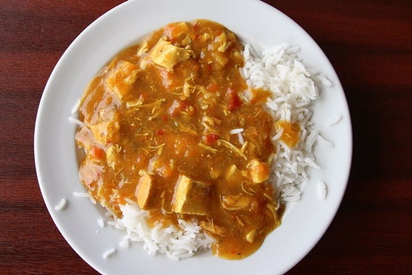 A plate of chicken curry over rice