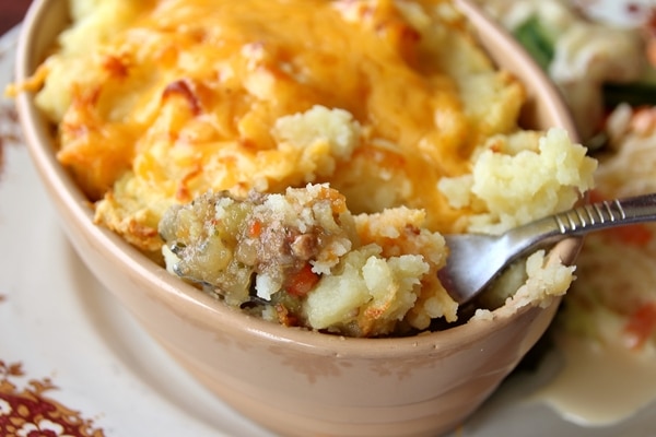 A close up of a forkful of shepherd\'s pie