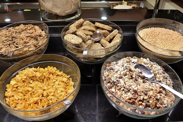 large bowls of granola and cereal on a buffet line