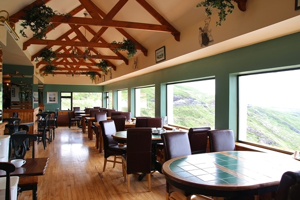 an empty restaurant dining room with large windows