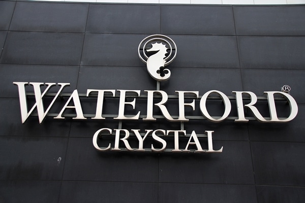 A sign on the side of a building that says Waterford Crystal