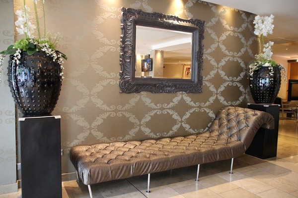 a chaise lounge and mirror