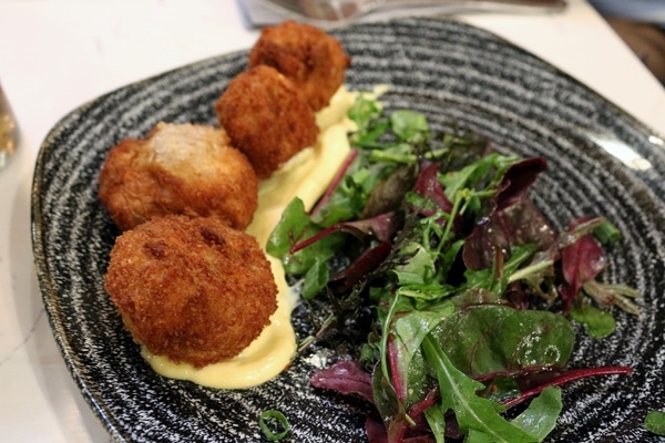 fried mushrooms on a plate with salad