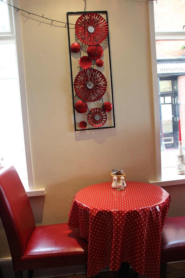 a red chair and red covered table in a restaurant