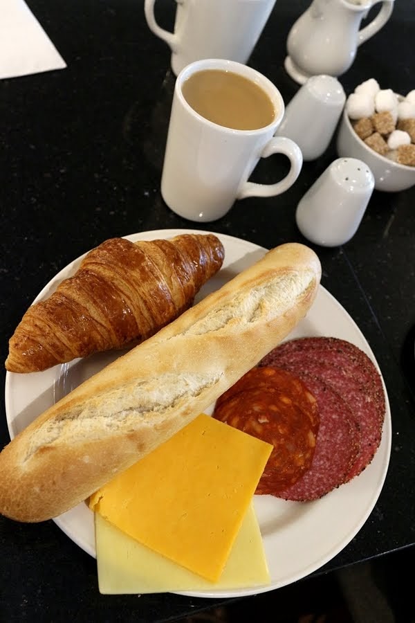 A plate of food and a cup of coffee