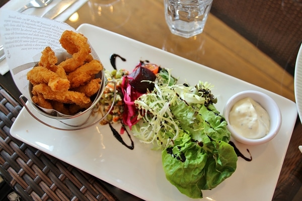 A plate of fried chicken tenders with salad