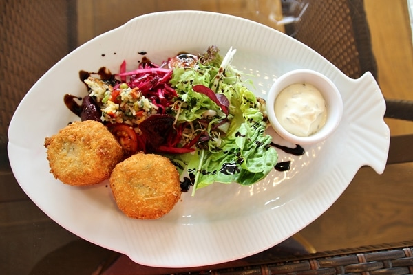 fish cakes on a plate with salads