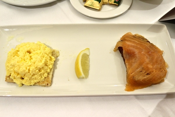 toasts topped with scrambled eggs and smoked salmon