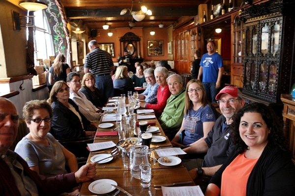 A group of people sitting at a table in a restaurant