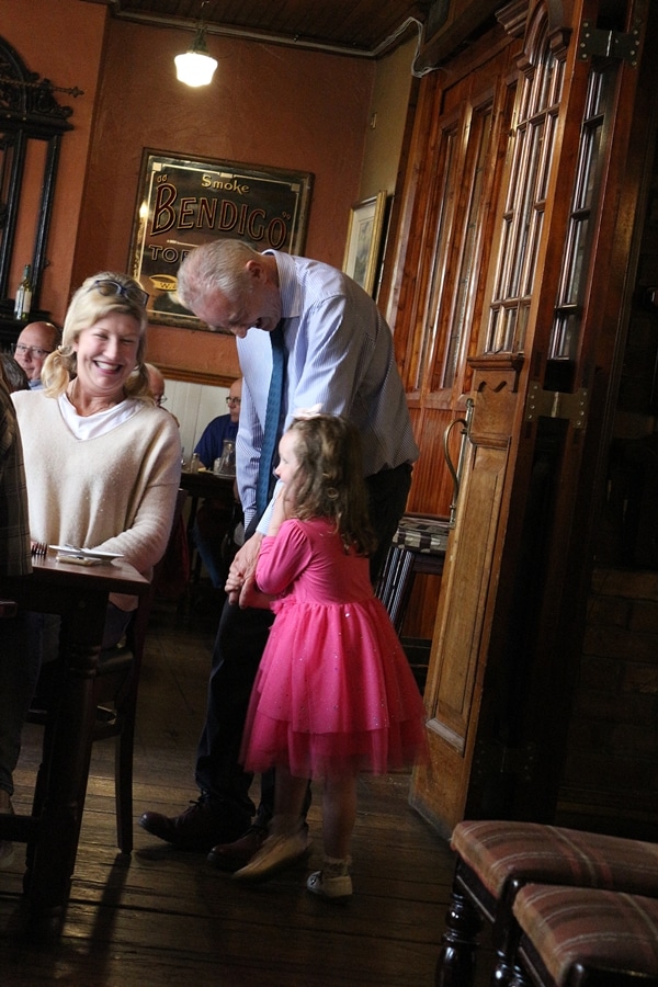 A man, a woman, and child in a restaurant