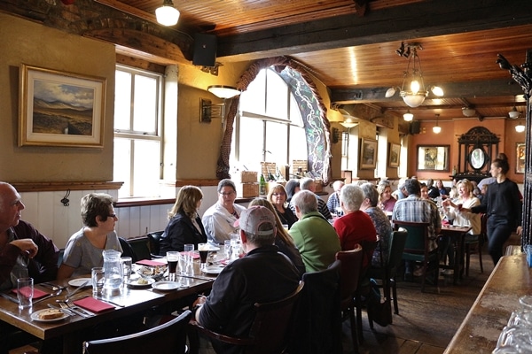 A group of people sitting at a table in a restaurant