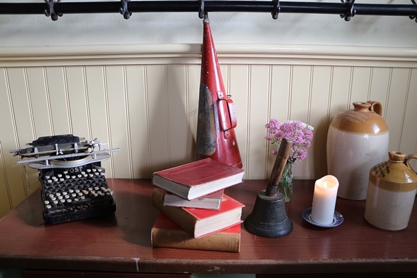 a table with books and a typewriter