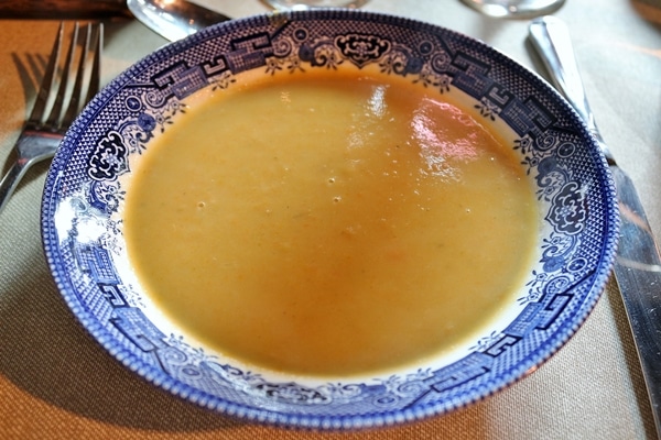 A bowl of soup in a blue and white dish