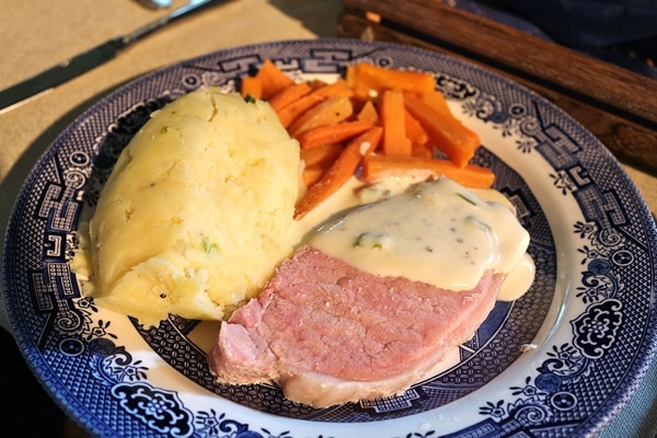 A plate of food with pork and potatoes