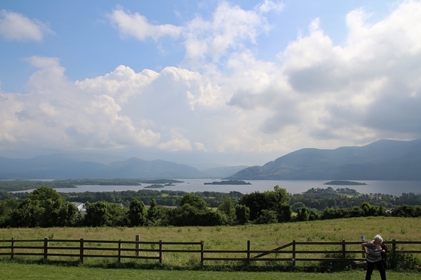 wide view of a park with a lake and mountains