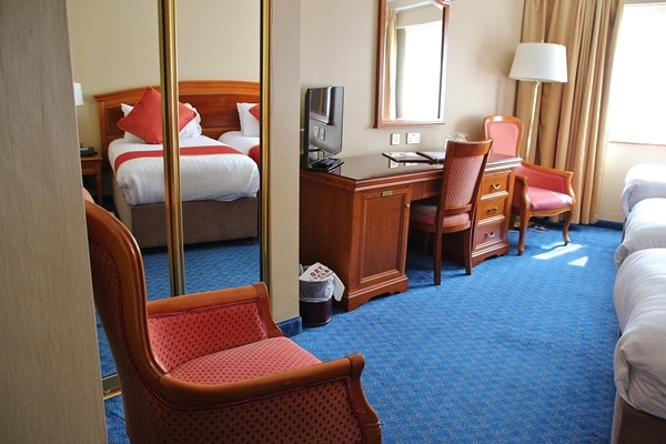 a hotel bedroom with a desk