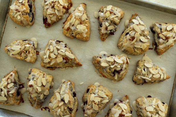 scones topped with almonds on a baking sheet